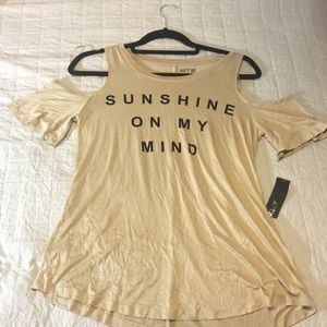 Brand new tan shoulder cut shirt in women’s XS.